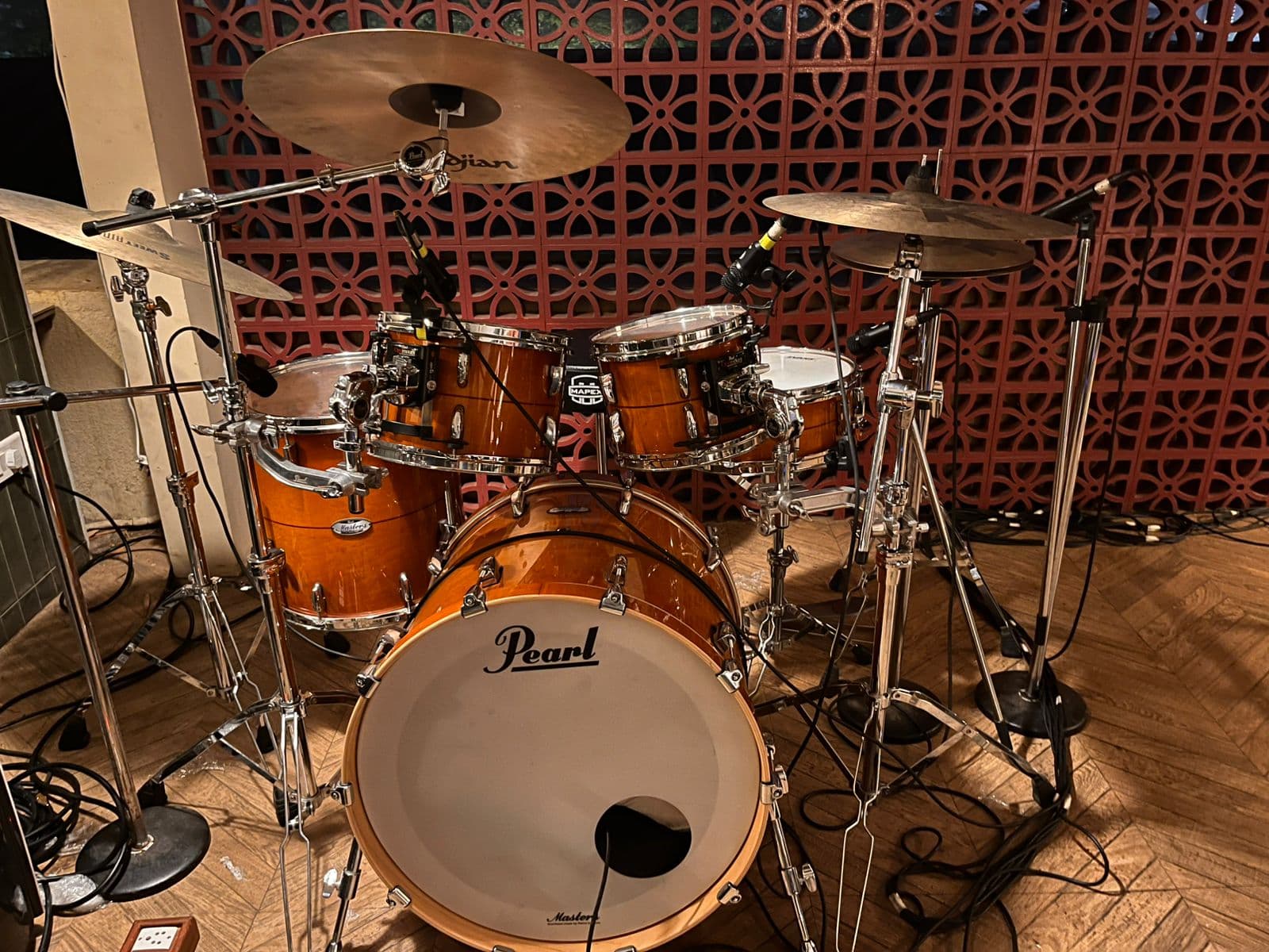 Drum kit, bass, and speaker setup in a session environment.