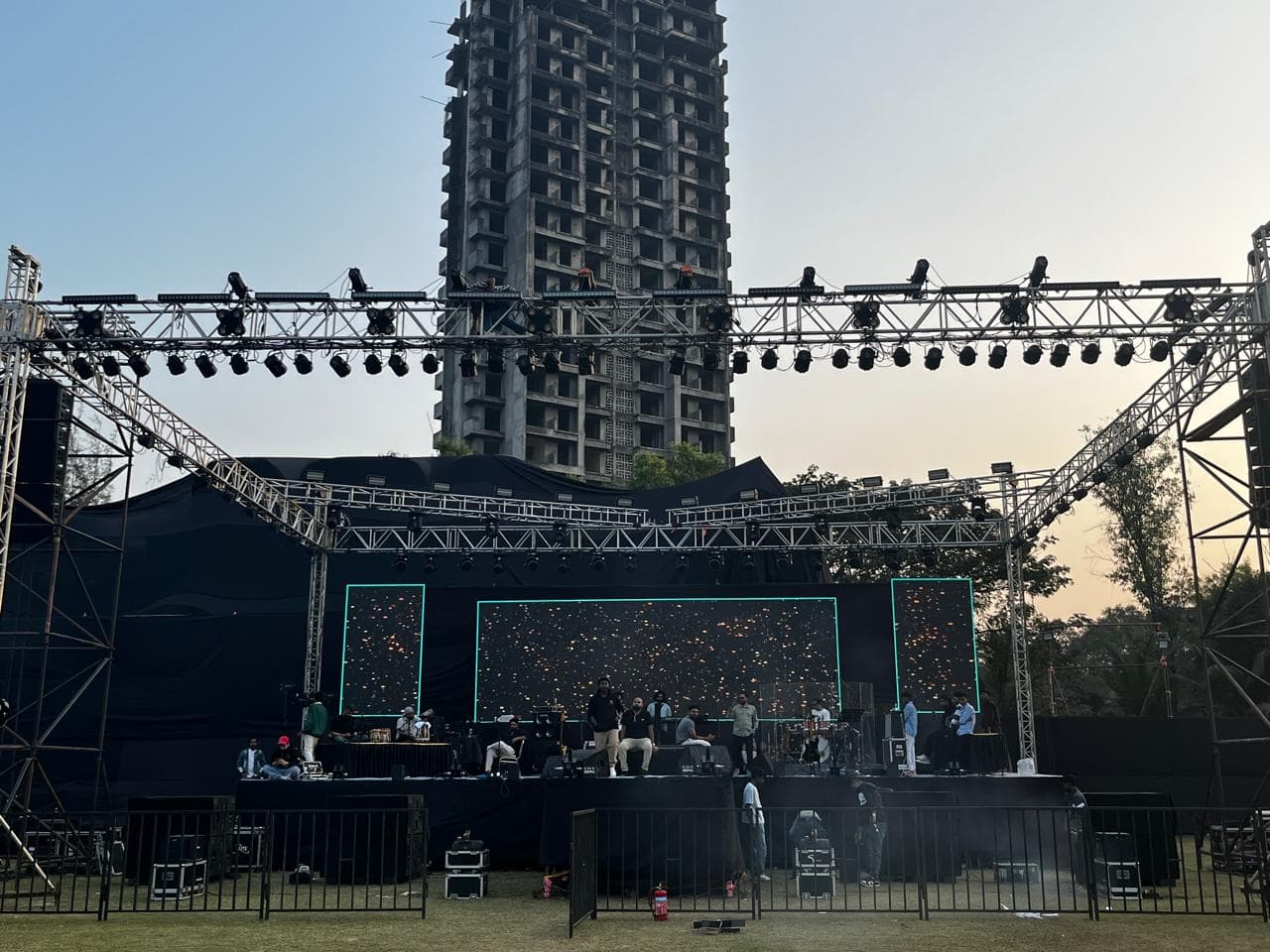 Wide outdoor stage build with truss and lighting system.