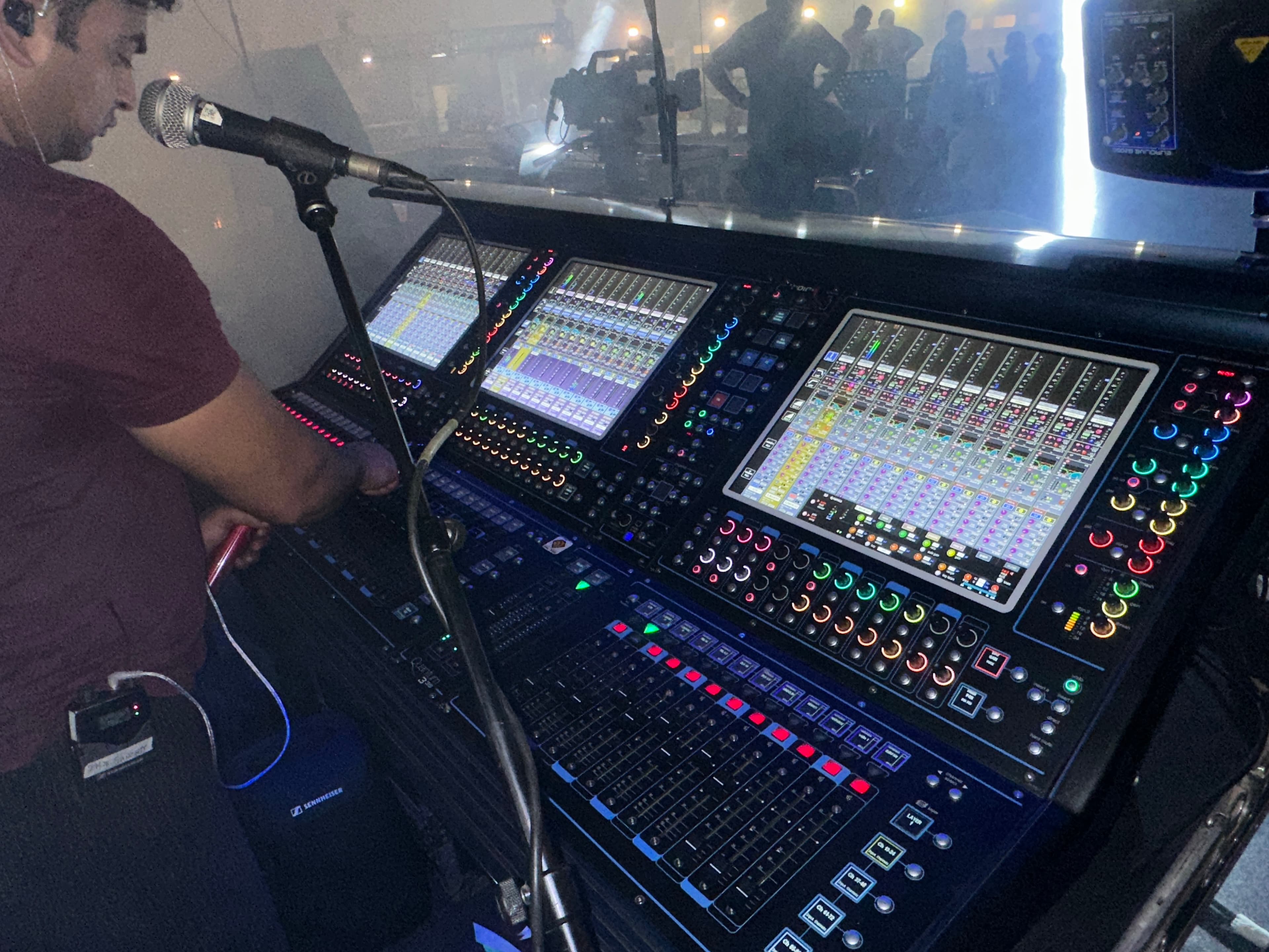 Engineer operating a live console during a show.