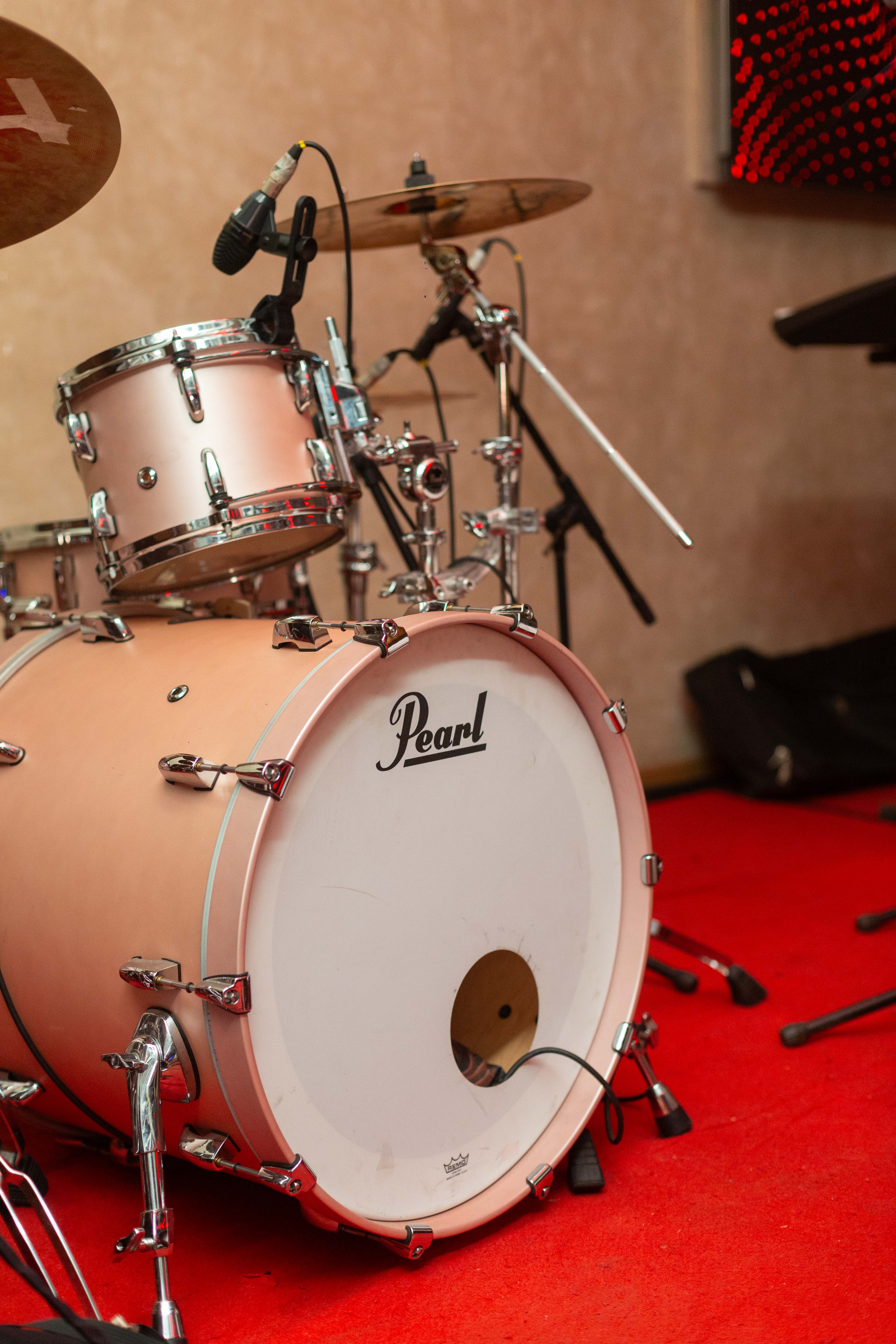 Close-up of a drum kit inside a performance and recording environment.